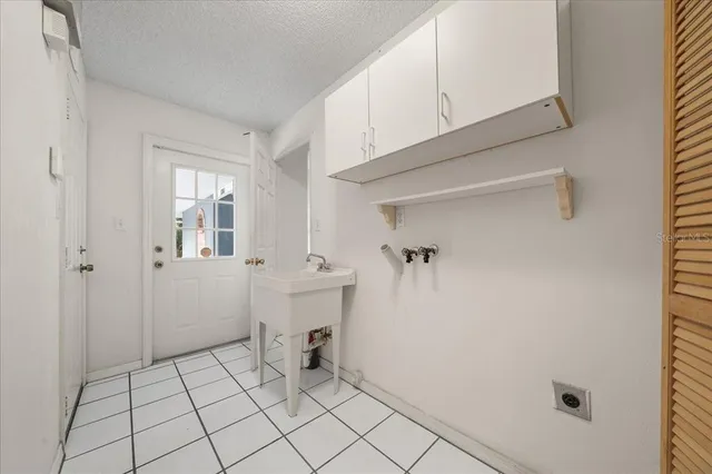 a spacious bedroom with a bed and a flat screen tv