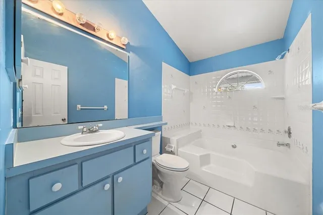 a bathroom with a toilet a sink and bathtub