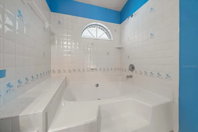 an empty room with chandelier fan