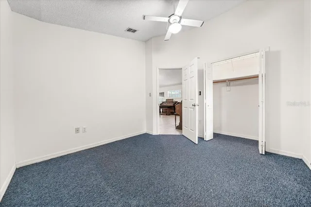 an empty room with windows and closet