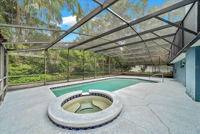 a view of a backyard with furniture and a swimming pool