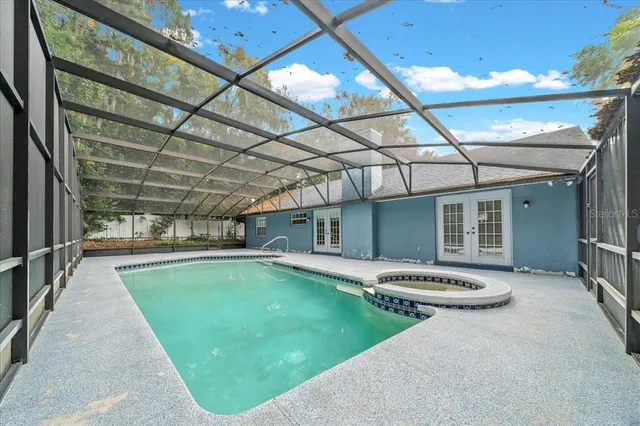 a view of a entrance gate of the house and trees