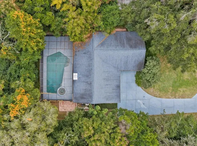 an aerial view of a house with a yard