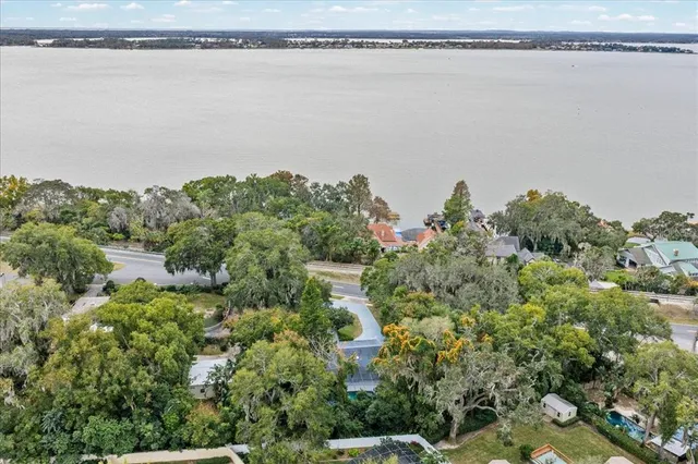 an aerial view of a houses with a lake view