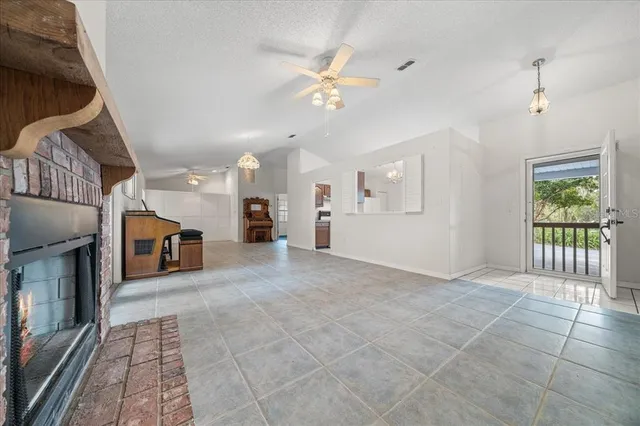 a view of living room with furniture and a fireplace