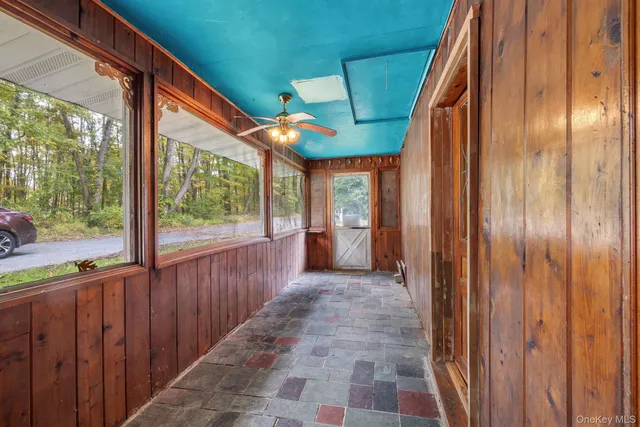 a view of a porch with wooden floor and outdoor space