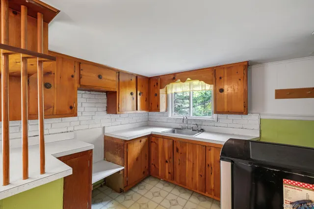 a kitchen with a sink and a window