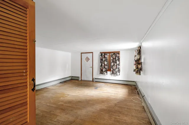 an empty room with windows and closet