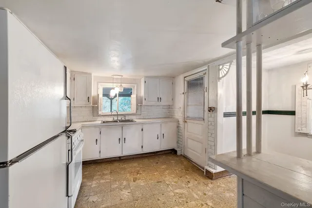 a kitchen with granite countertop a sink and a stove
