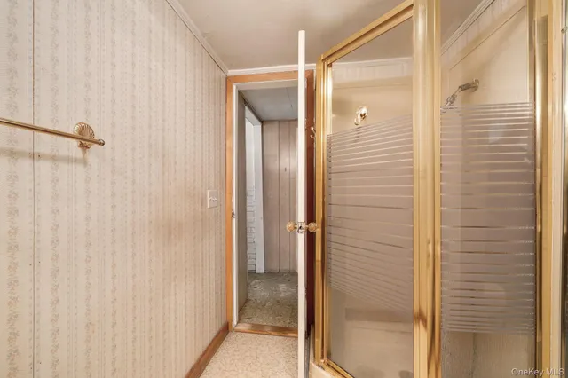 a bathroom with a shower and a glass door