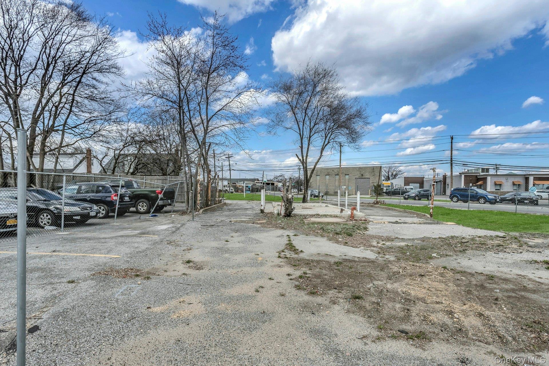 899 Old Country Road Westbury, NY 11590 - Photo 15 of 19 Uncovered parking lot featuring fence