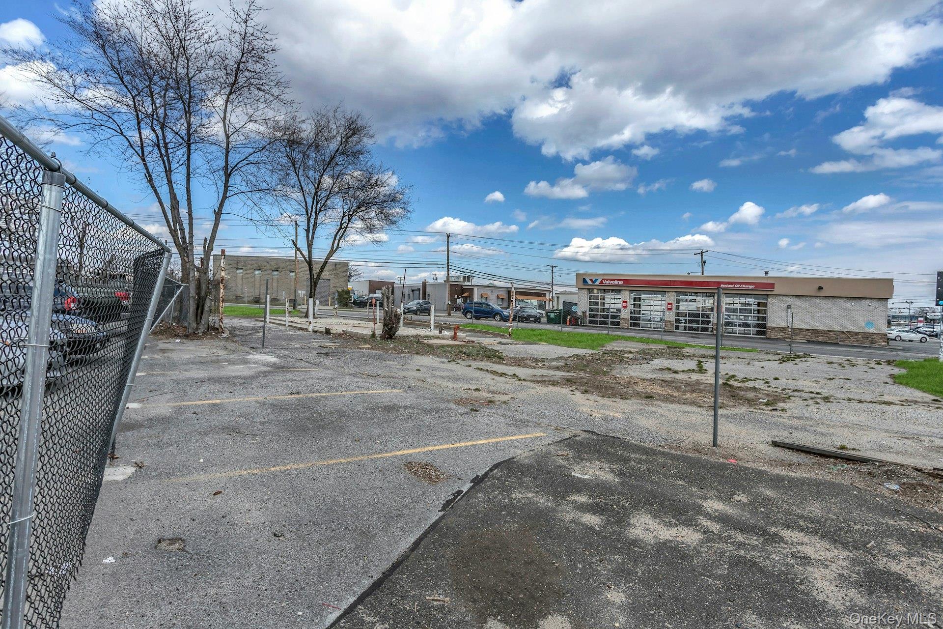 899 Old Country Road Westbury, NY 11590 - Photo 8 of 19 Uncovered parking lot featuring fence