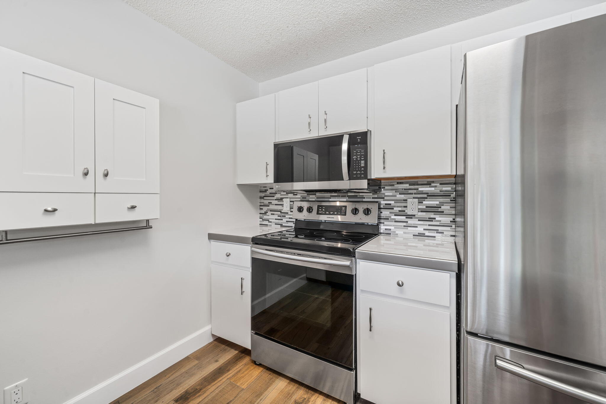 17876 43rd Road North Loxahatchee, FL 33470 - Photo 12 of 37 a kitchen with white cabinets and stainless steel appliances