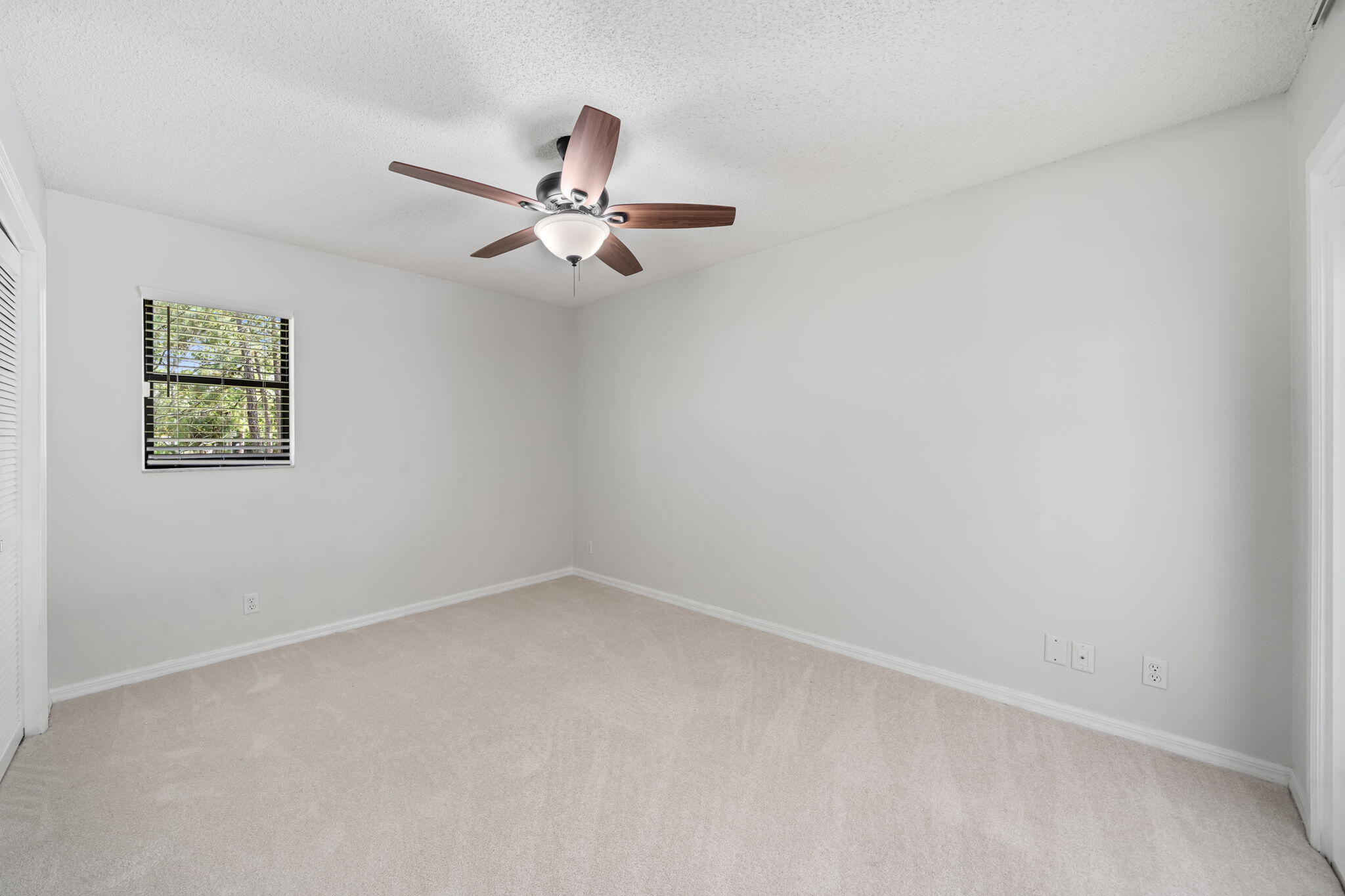 17876 43rd Road North Loxahatchee, FL 33470 - Photo 17 of 37 an empty room with a window and ceiling fan