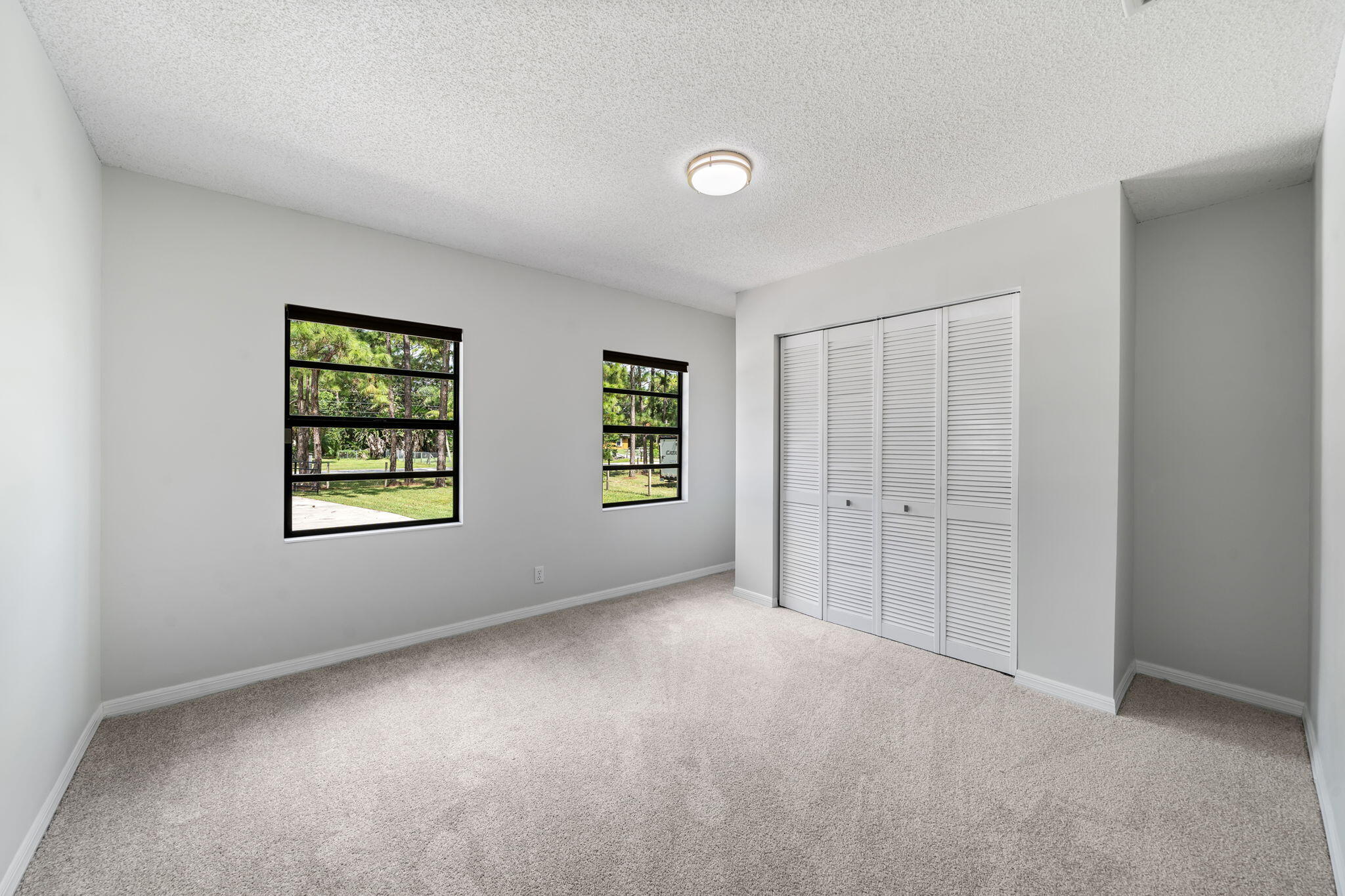 17876 43rd Road North Loxahatchee, FL 33470 - Photo 19 of 37 an empty room with windows and closet