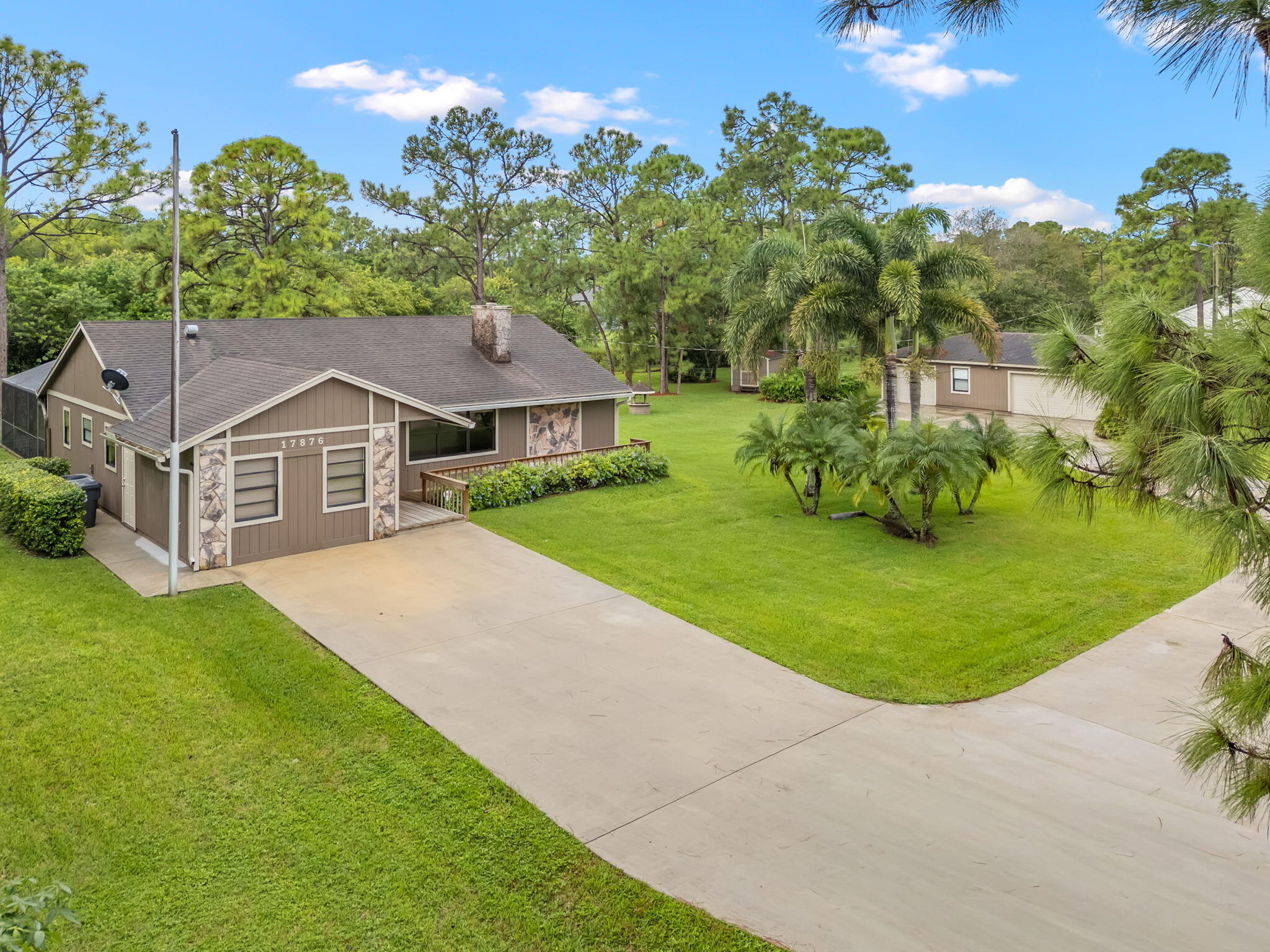 17876 43rd Road North Loxahatchee, FL 33470 - Photo 27 of 37 a aerial view of a house with a yard and large trees