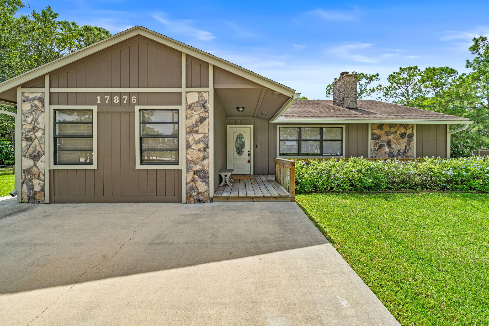 17876 43rd Road North Loxahatchee, FL 33470 - Photo 28 of 37 a front view of a house with a yard and garage