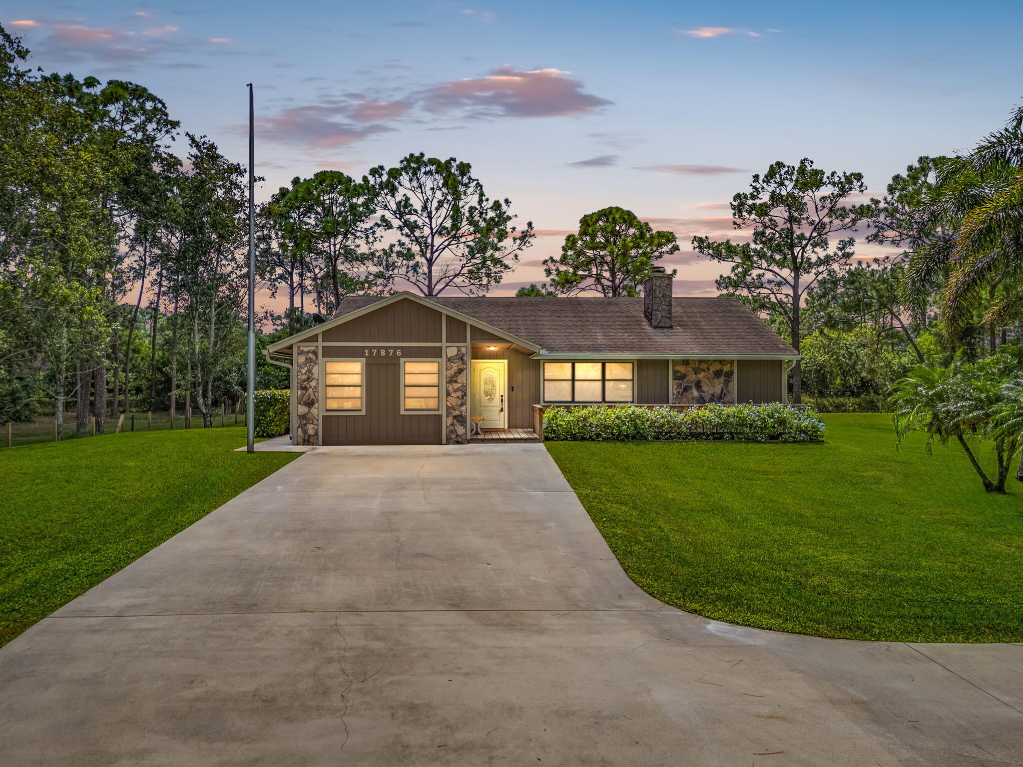 17876 43rd Road North Loxahatchee, FL 33470 - Photo 36 of 37 a front view of a house with a yard and garage