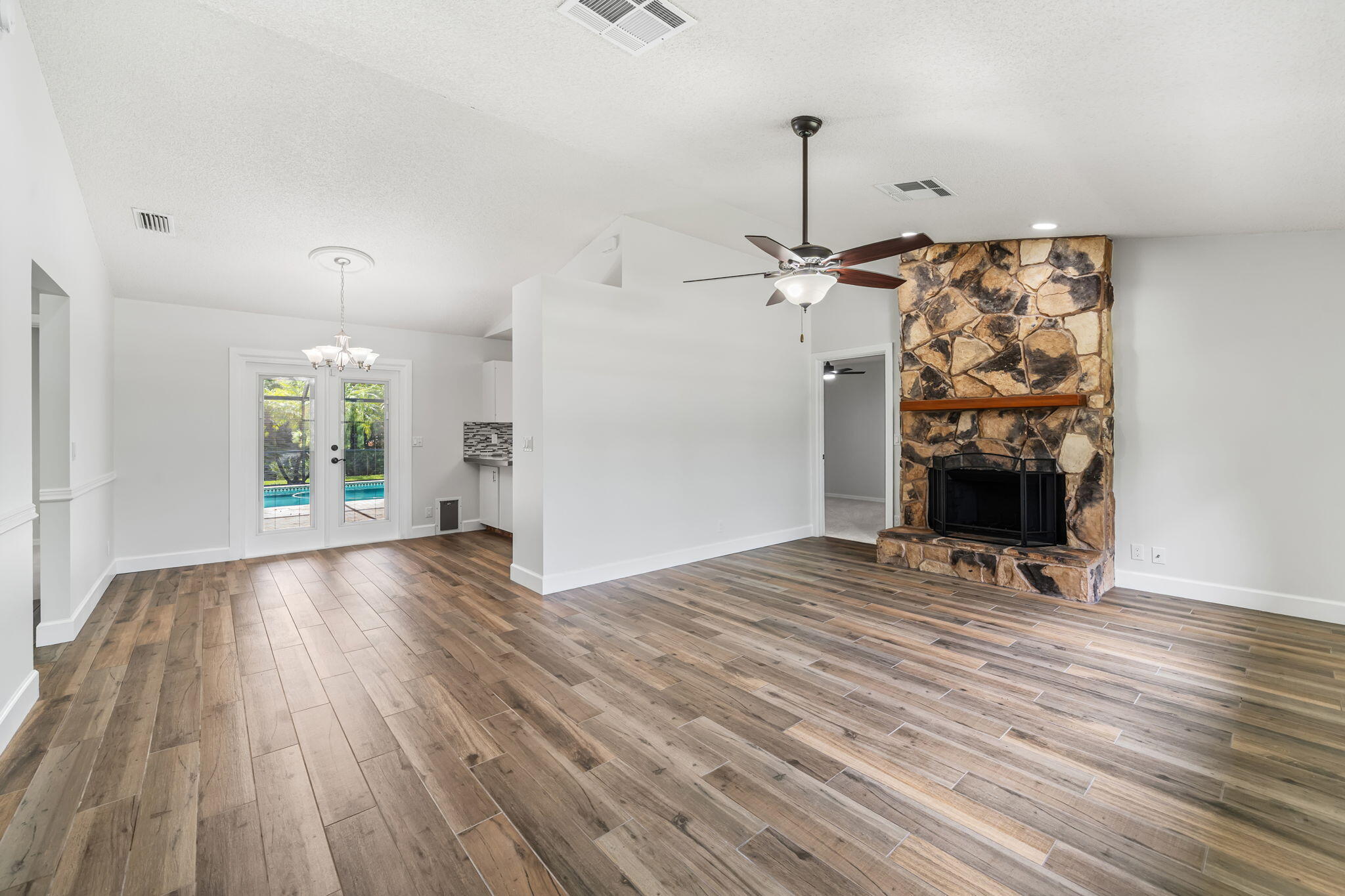 17876 43rd Road North Loxahatchee, FL 33470 - Photo 7 of 37 a view of empty room with wooden floor and fireplace