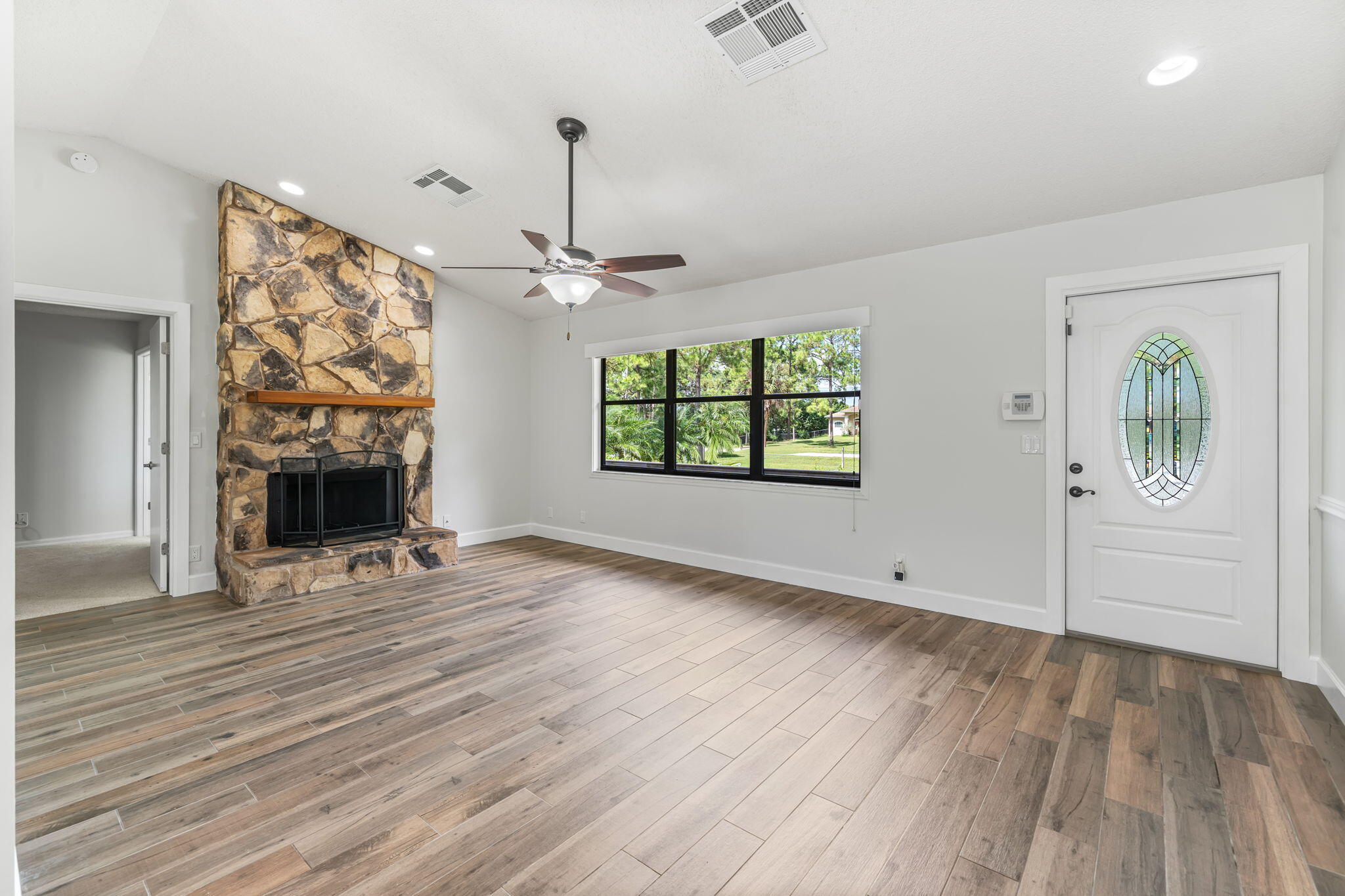 17876 43rd Road North Loxahatchee, FL 33470 - Photo 9 of 37 an empty room with windows and fireplace