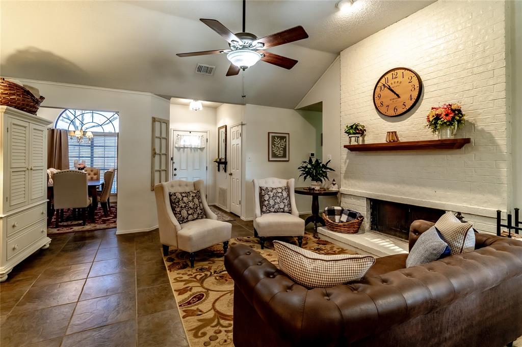 266 East Ridgegate Drive Garland, TX 75040 - Photo 13 of 32 a living room with furniture a fireplace and a chandelier