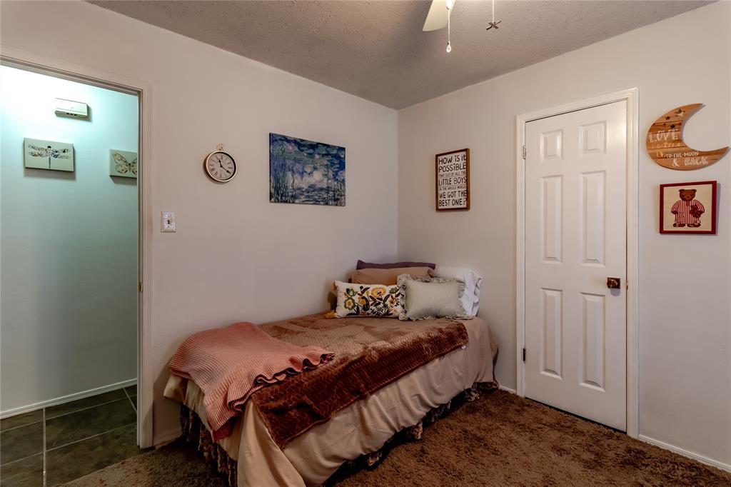266 East Ridgegate Drive Garland, TX 75040 - Photo 25 of 32 a bedroom with a bed and painting on the wall