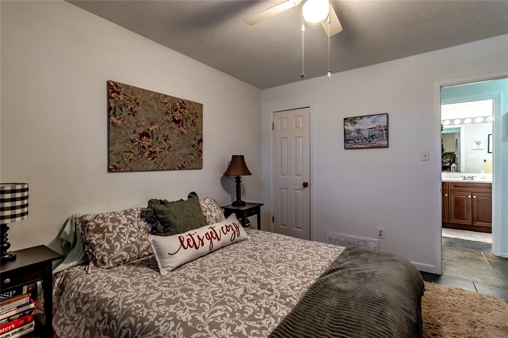 266 East Ridgegate Drive Garland, TX 75040 - Photo 28 of 32 a bedroom with a bed and a cabinets