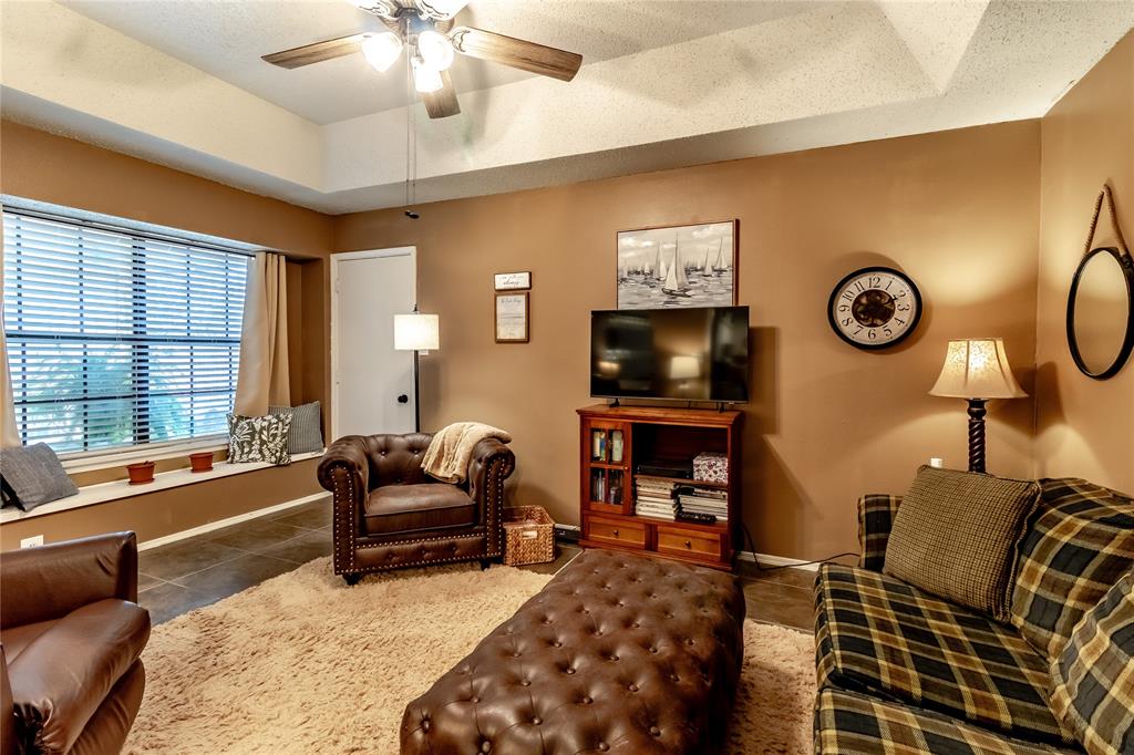 266 East Ridgegate Drive Garland, TX 75040 - Photo 10 of 32 a living room with furniture a flat screen tv and a large window