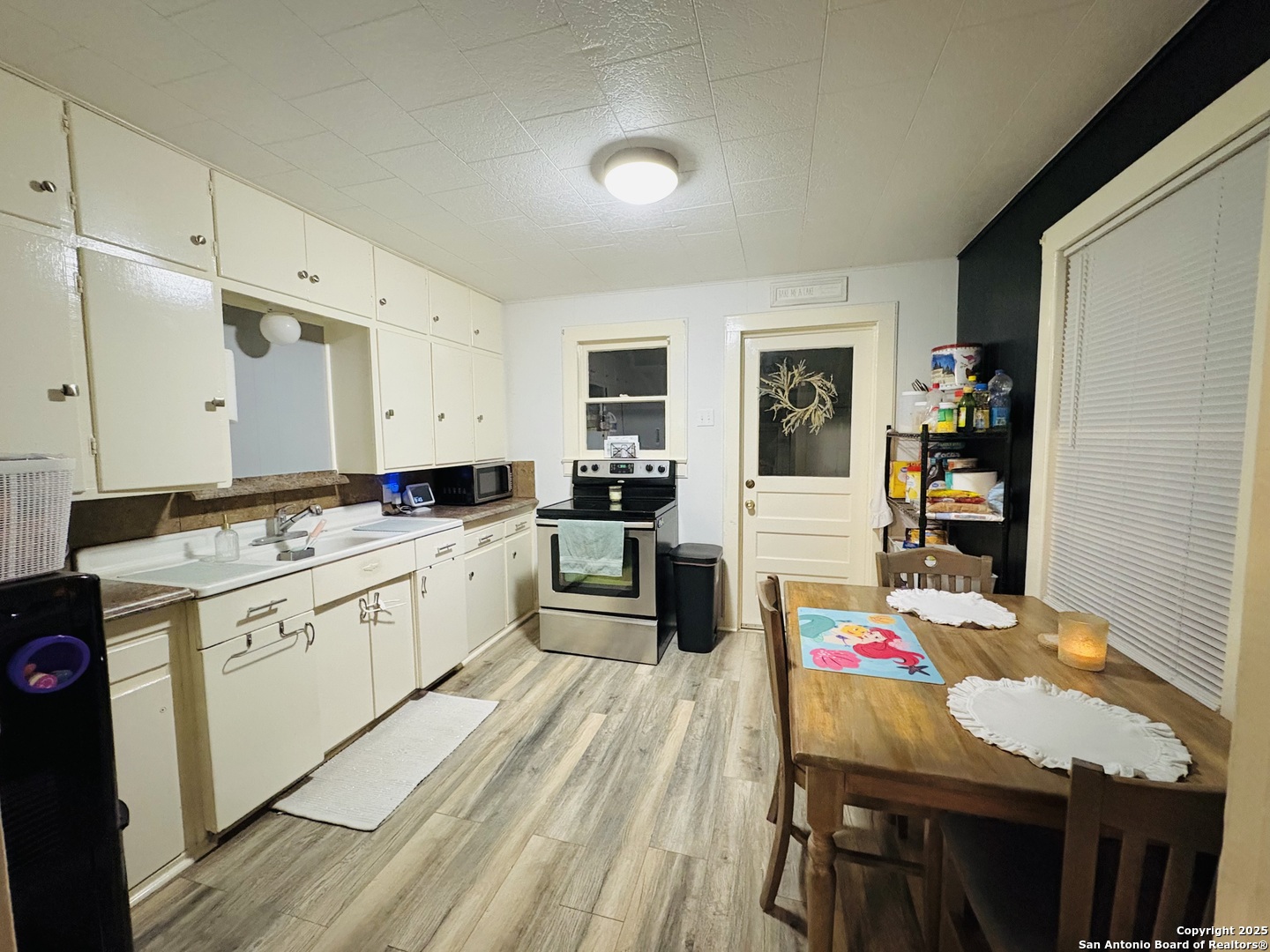 609 East Nopal Street Uvalde, TX 78801 - Photo 2 of 7 a kitchen that has a lot of cabinets a sink and a stove in it