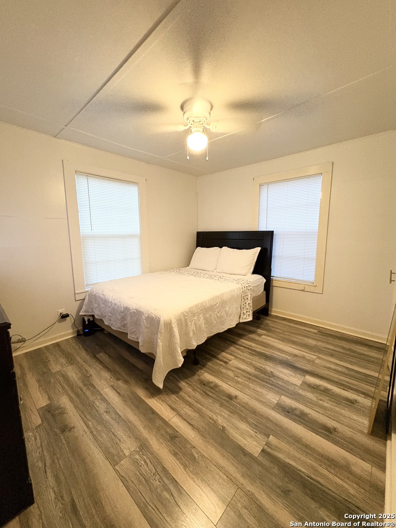 609 East Nopal Street Uvalde, TX 78801 - Photo 4 of 7 a bedroom with a bed and a chandelier