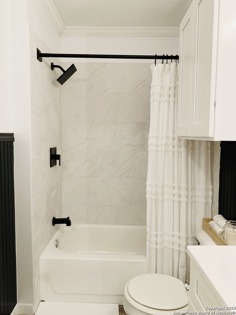 609 East Nopal Street Uvalde, TX 78801 - Photo 6 of 7 a bathroom with a toilet and a shower