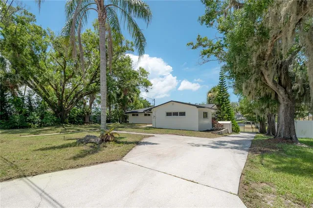 a view of a kitchen with a sink and dishwasher a refrigerator with wooden floor