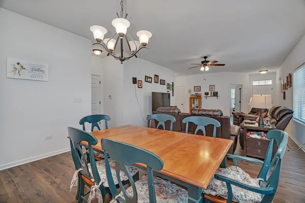 a view of a dining room with furniture and chandelier