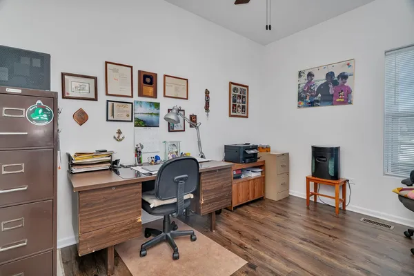 a view of a workspace with furniture and a workspace