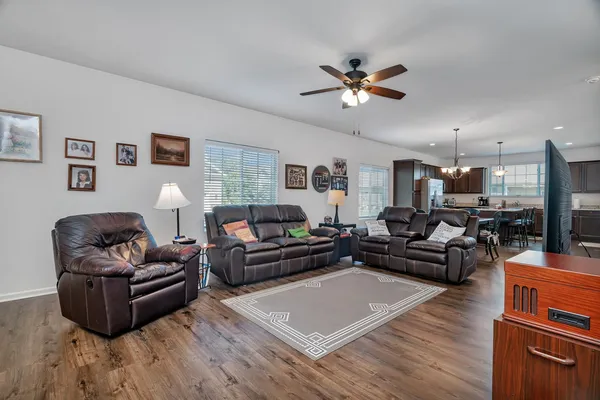 a living room with furniture and a wooden floor
