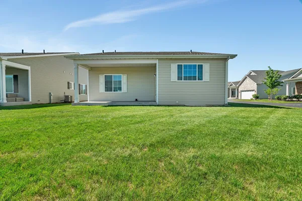 a front view of house with yard and green space