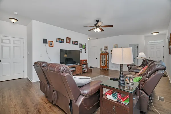 a living room with furniture a flat screen tv and a fireplace