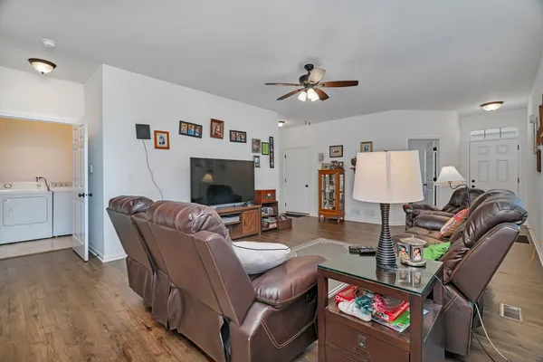 a living room with furniture a flat screen tv and a fireplace