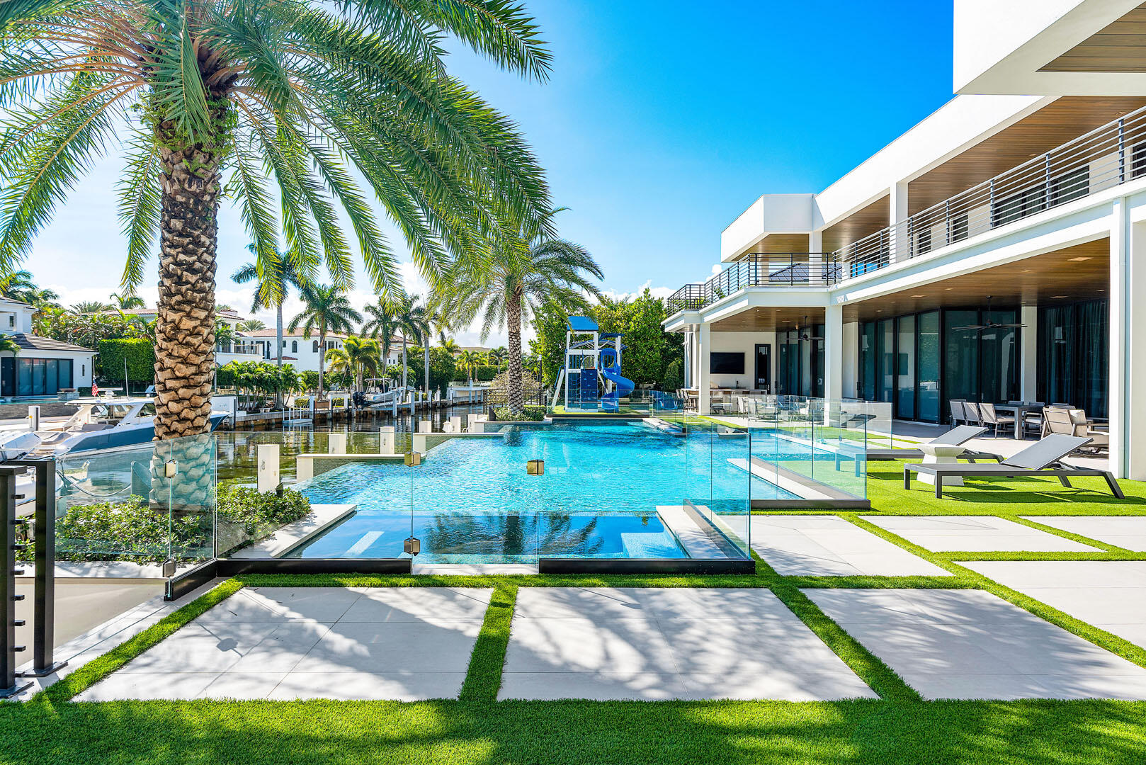 298 West Key Palm Road Boca Raton, FL 33432 - Photo 18 of 82 a view of swimming pool with lawn chairs and plants