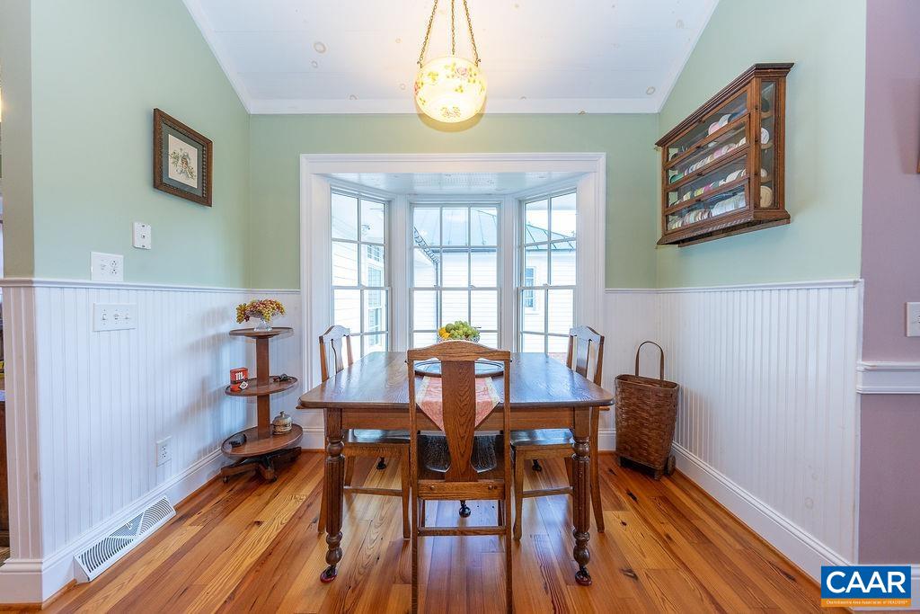 1571 Celt Road Stanardsville, VA 22973 - Photo 18 of 66 a view of a dining room with furniture a chandelier and wooden floor