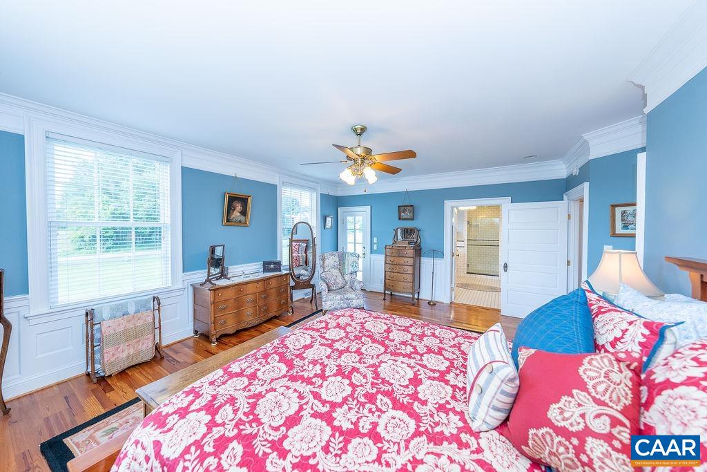 1571 Celt Road Stanardsville, VA 22973 - Photo 20 of 66 a bedroom with a bed and a chandelier