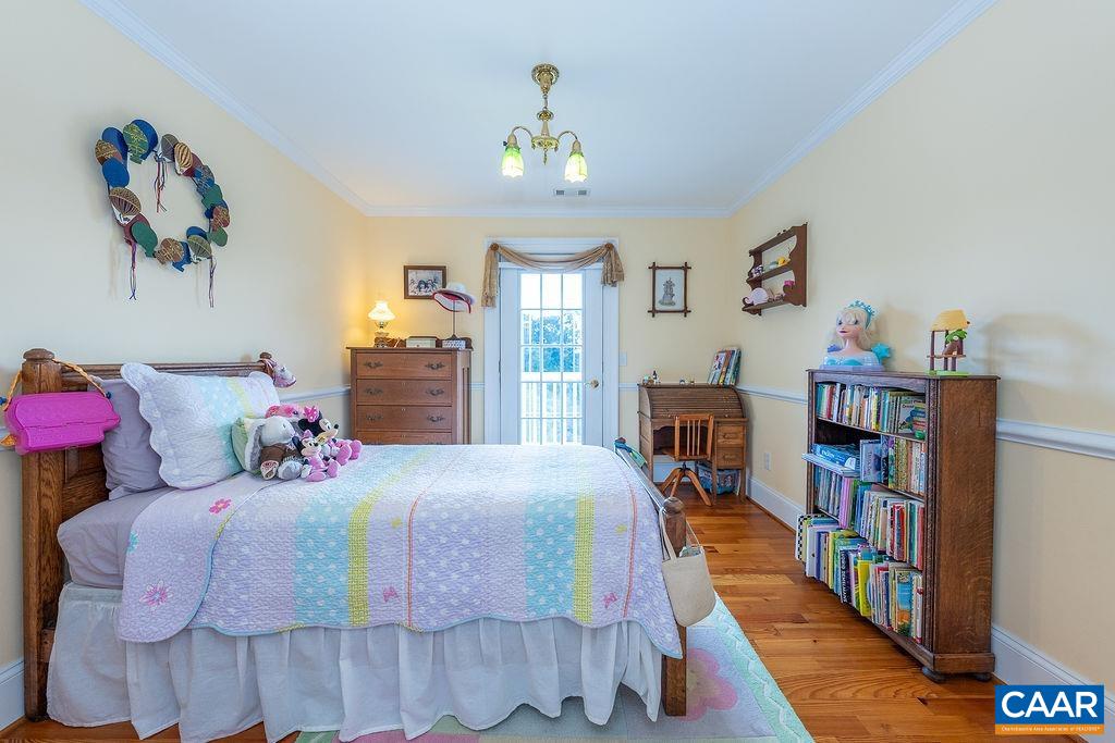 1571 Celt Road Stanardsville, VA 22973 - Photo 30 of 66 a bedroom with a bed and a book shelf