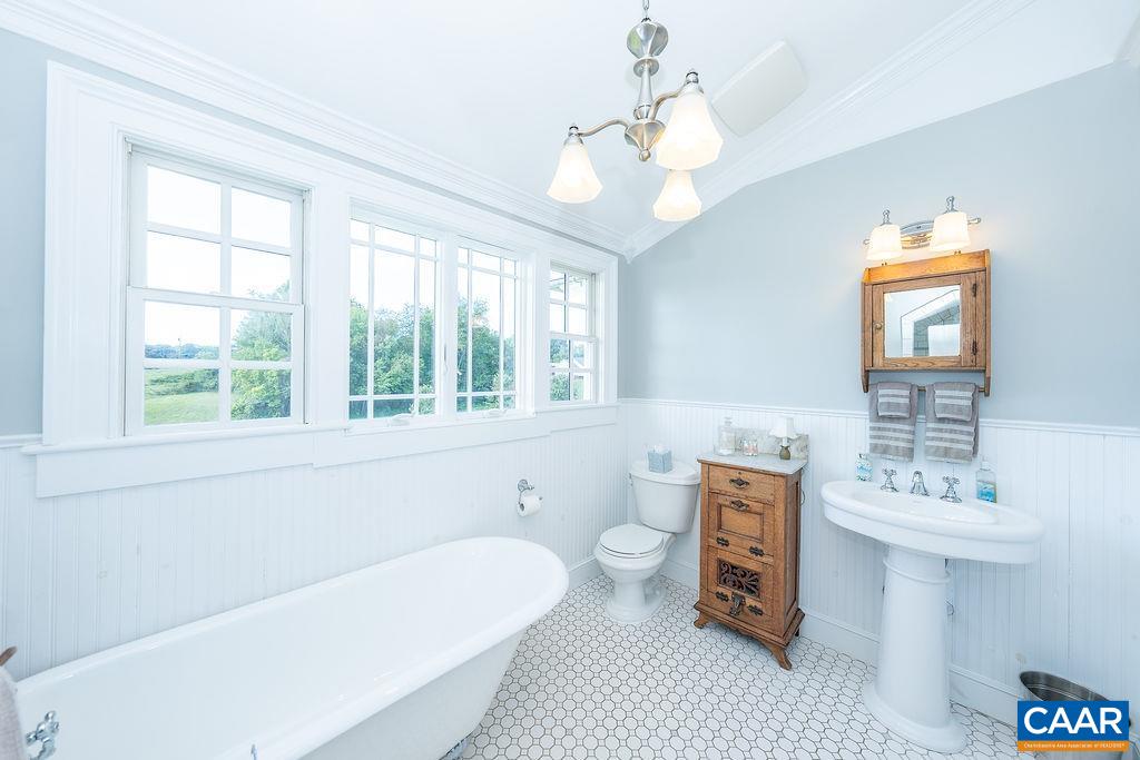 1571 Celt Road Stanardsville, VA 22973 - Photo 31 of 66 a spacious bathroom with a bathtub a sink and a window