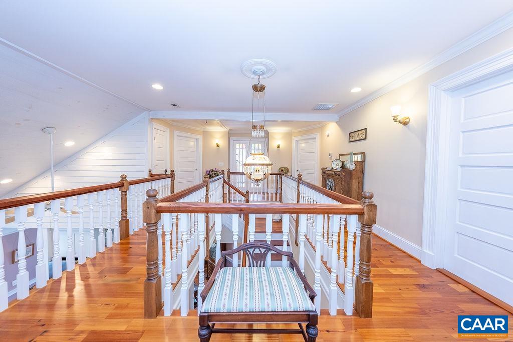 1571 Celt Road Stanardsville, VA 22973 - Photo 33 of 66 a view of a hallway with wooden floor and staircase