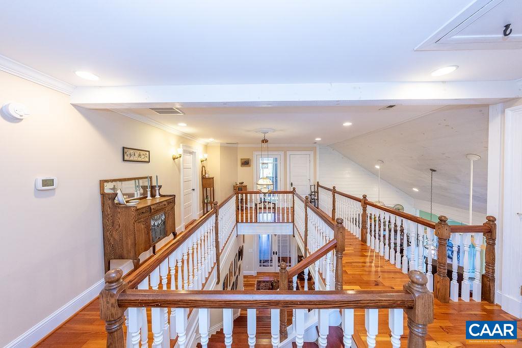 1571 Celt Road Stanardsville, VA 22973 - Photo 34 of 66 a view of staircase with lots of frames on wall and wooden floor