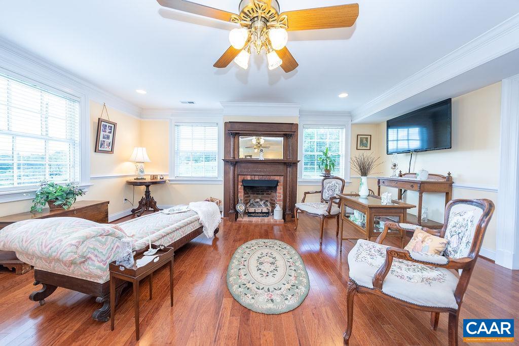 1571 Celt Road Stanardsville, VA 22973 - Photo 40 of 66 a living room with furniture a fireplace and a chandelier