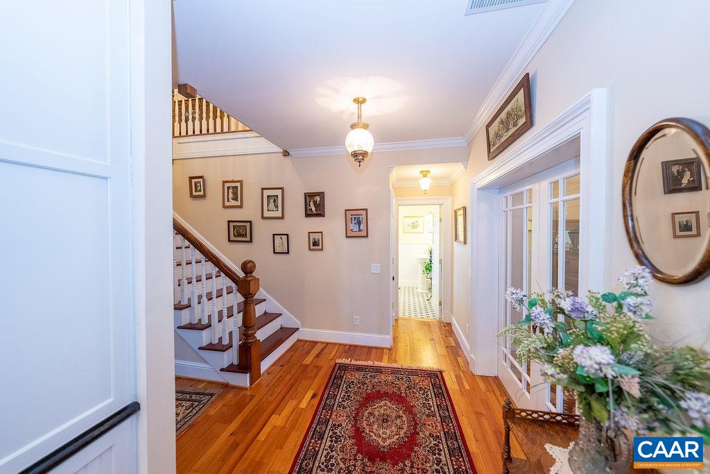 1571 Celt Road Stanardsville, VA 22973 - Photo 6 of 66 a view of a hallway with wooden floor and staircase