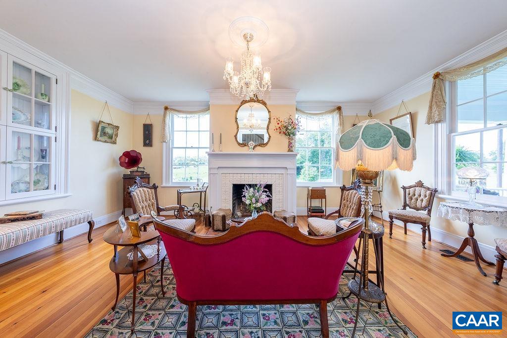 1571 Celt Road Stanardsville, VA 22973 - Photo 7 of 66 a living room with furniture a fireplace and a chandelier