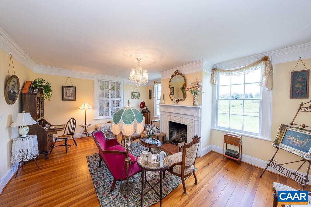 1571 Celt Road Stanardsville, VA 22973 - Photo 8 of 66 a living room with furniture a fireplace and wooden floor
