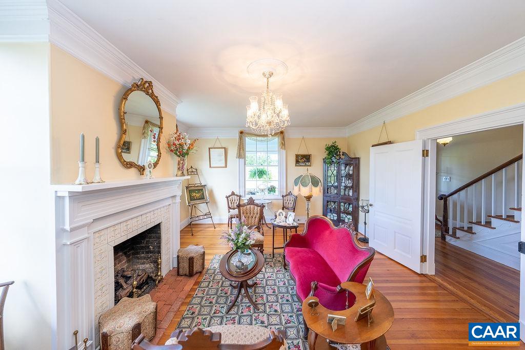 1571 Celt Road Stanardsville, VA 22973 - Photo 9 of 66 a living room with furniture a fireplace and a chandelier